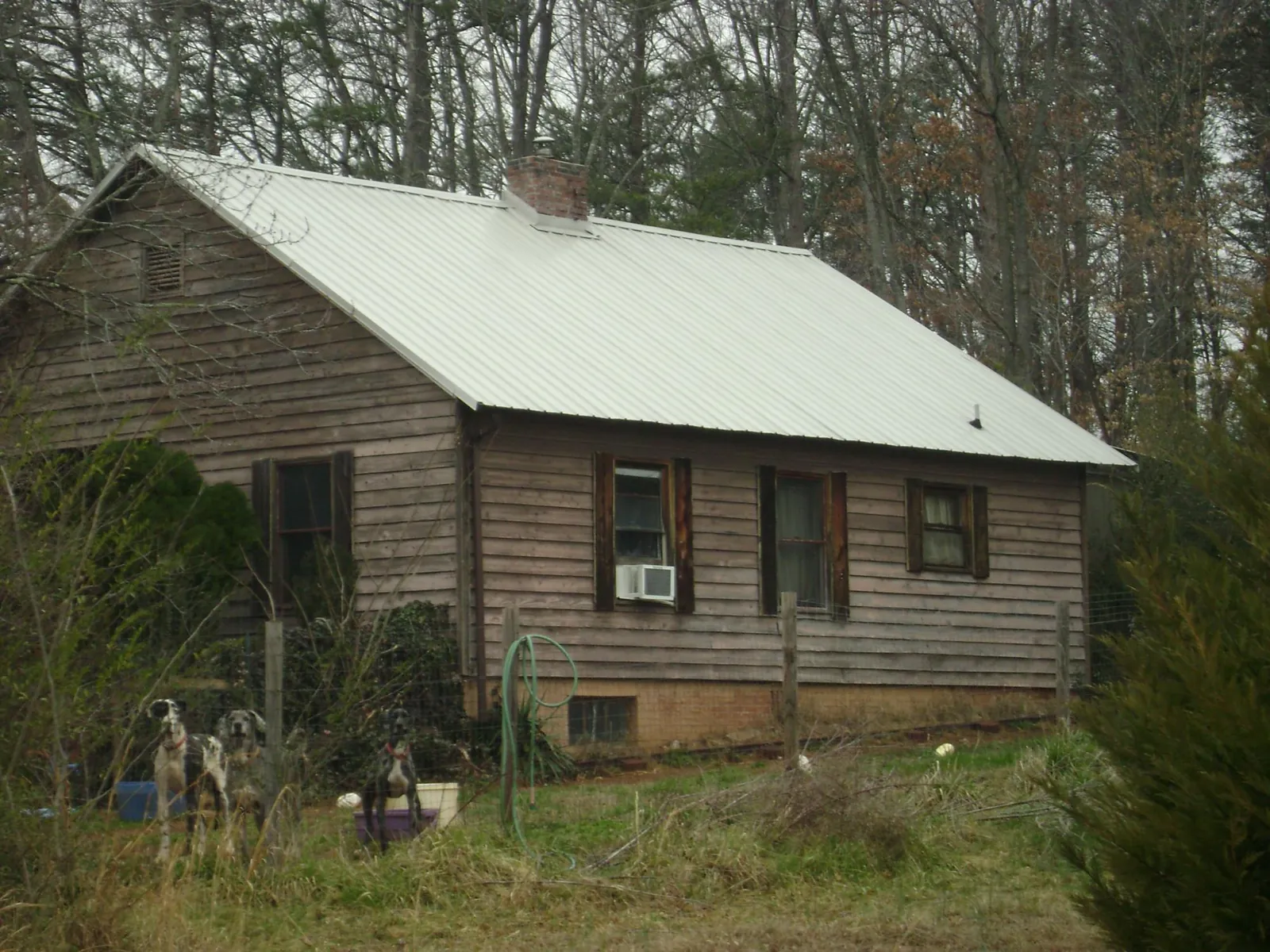 White metal roof on an old wood sided farmhouse, from a Metal Roof Installation job in Williamstown